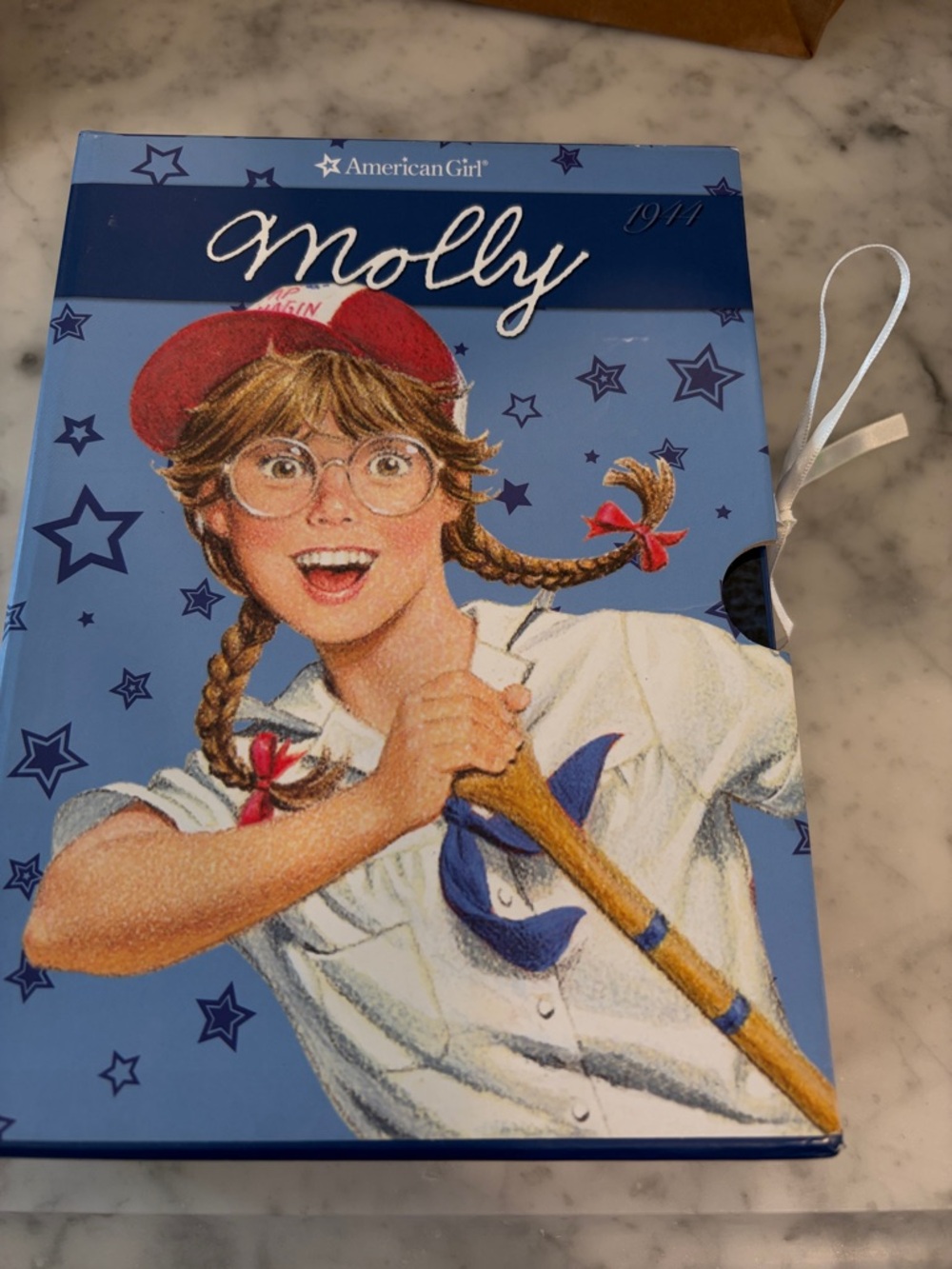 American Girl Molly Hardcover Story Box - Light Blue Background with Red Hat.